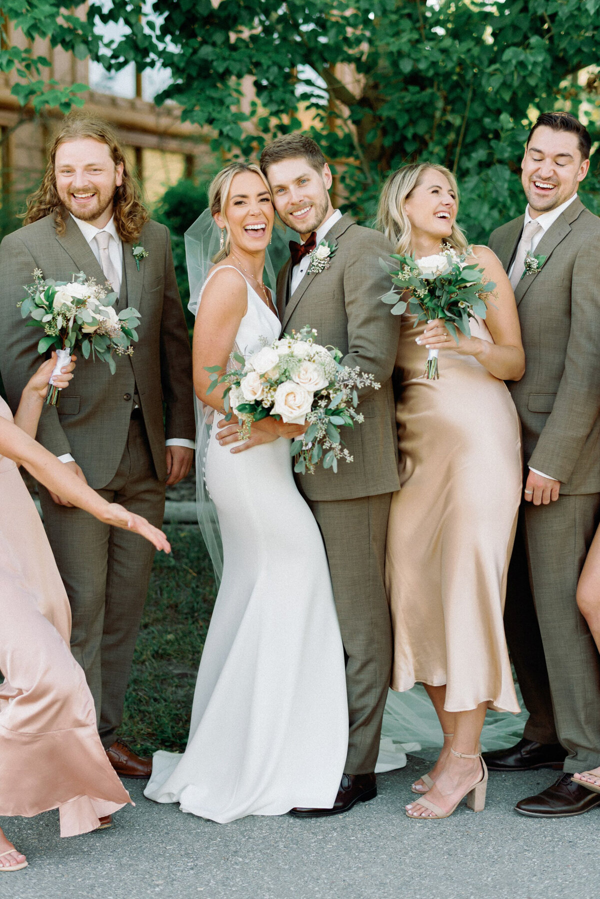 Bridal party laughing, captured by Kaity Body Photography, elegant film inspired wedding photographer in Calgary, Alberta. Featured on the Bronte Bride Vendor Guide.