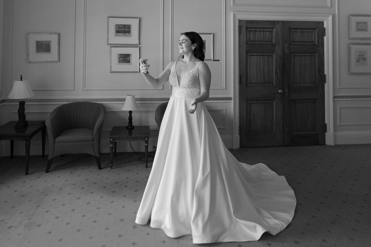 candid photo of bride standing in a room. black and white.