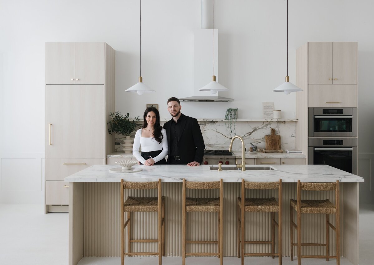 Caroline and Steven in a kitchen with marble countertops