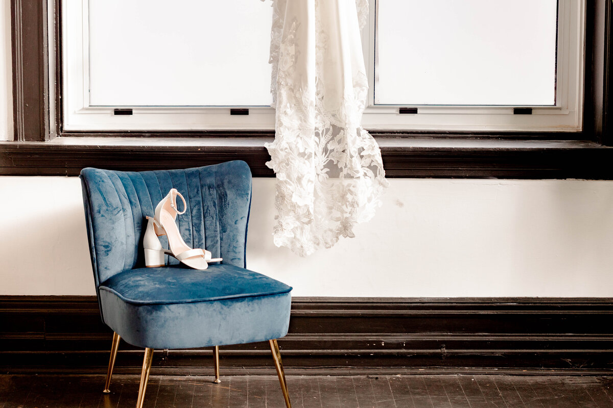 Elegant bridal dress and shoes captured by Style & Grace Photography in St. Louis, MO, highlighting the intricate details and beauty of the bride’s wedding attire.