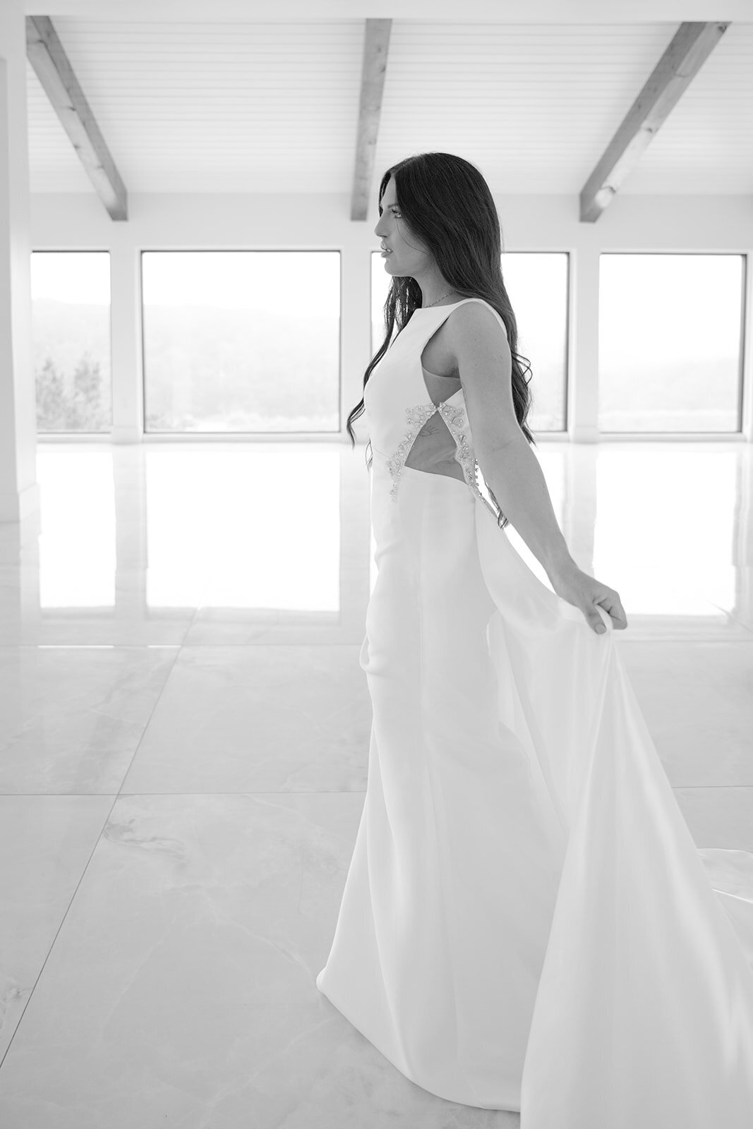 Black and white bridal portrait at The Videre Estate with elegant side profile and dramatic train.
