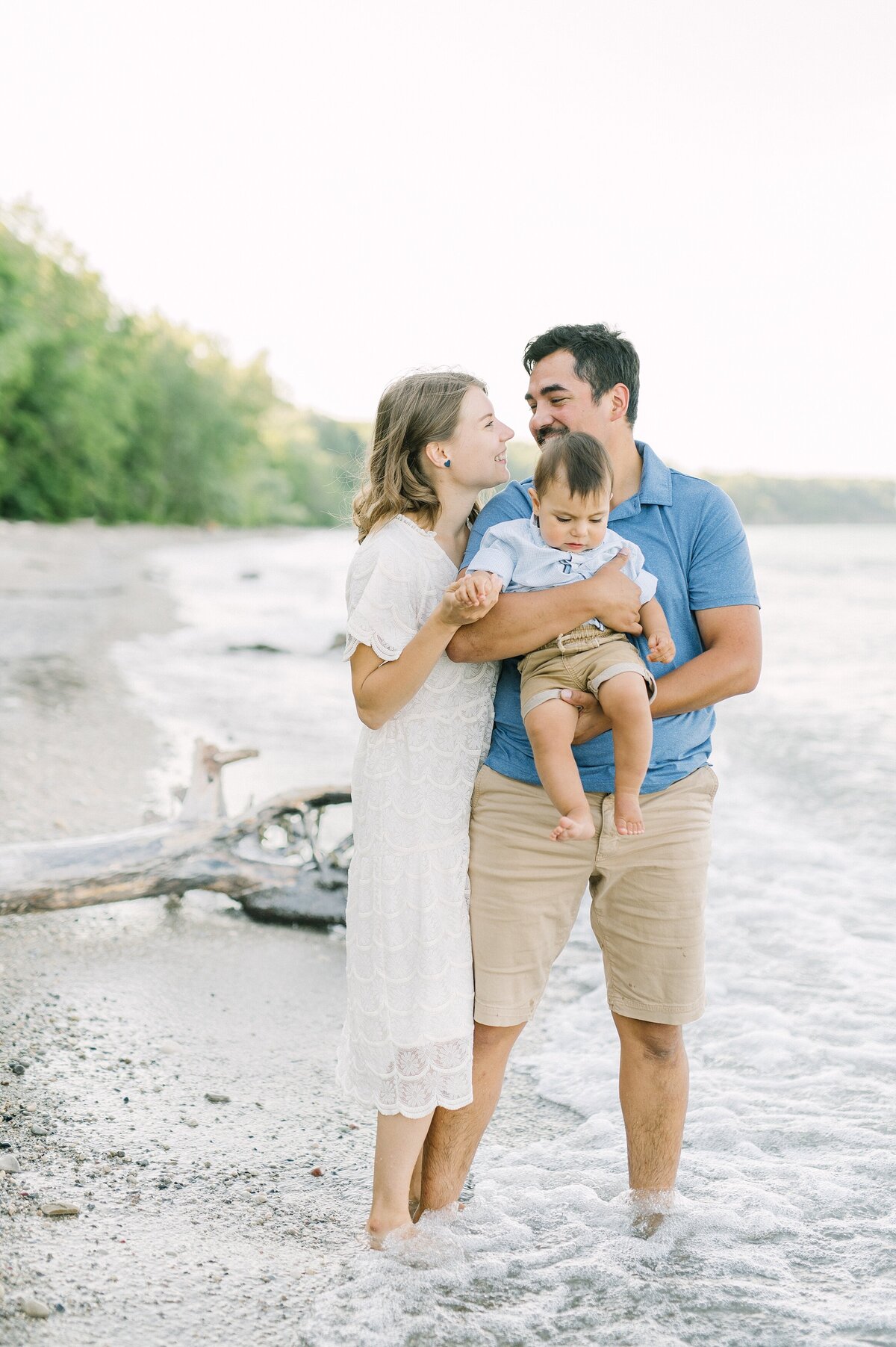 Family of three standing at Lake Michigan Beach in Milwaukee