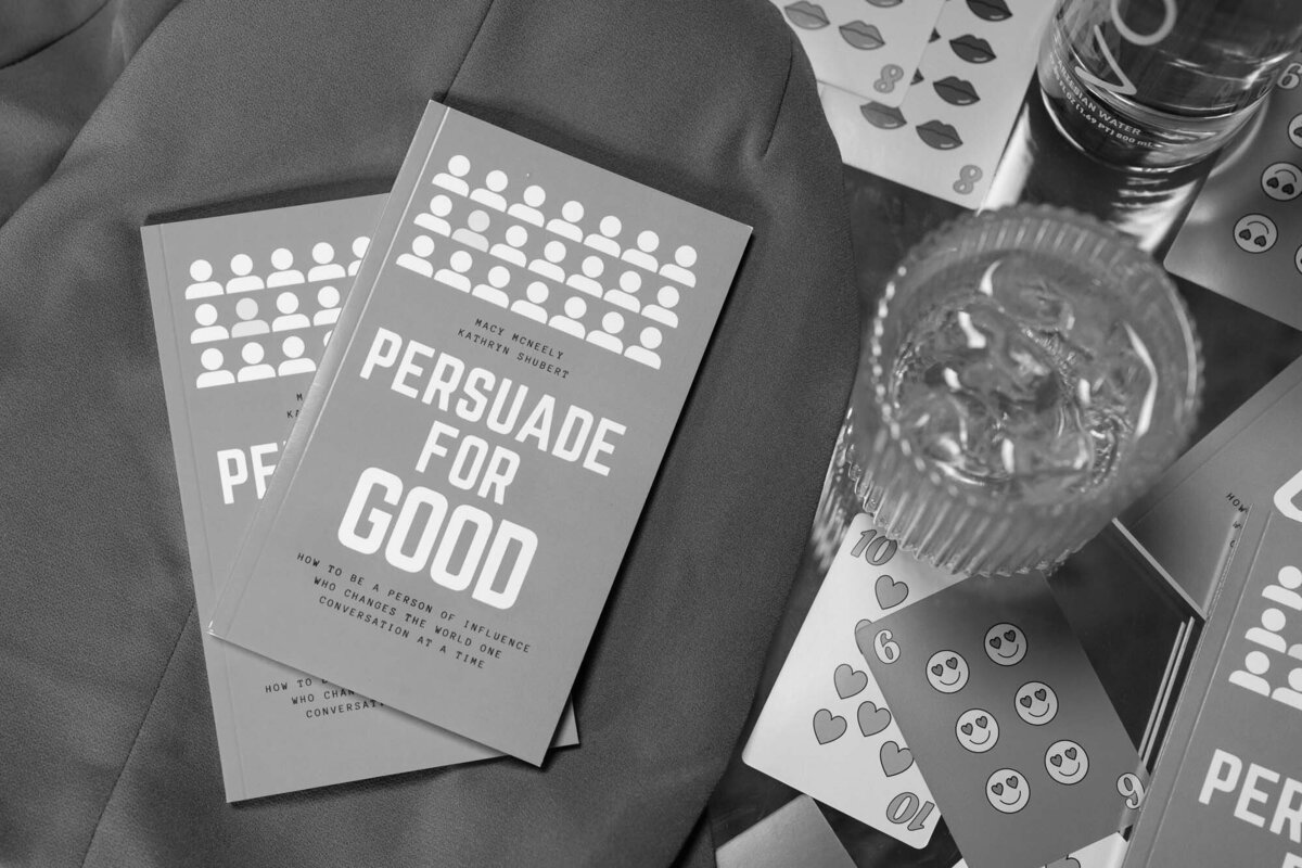 black and white photo of books and a glass