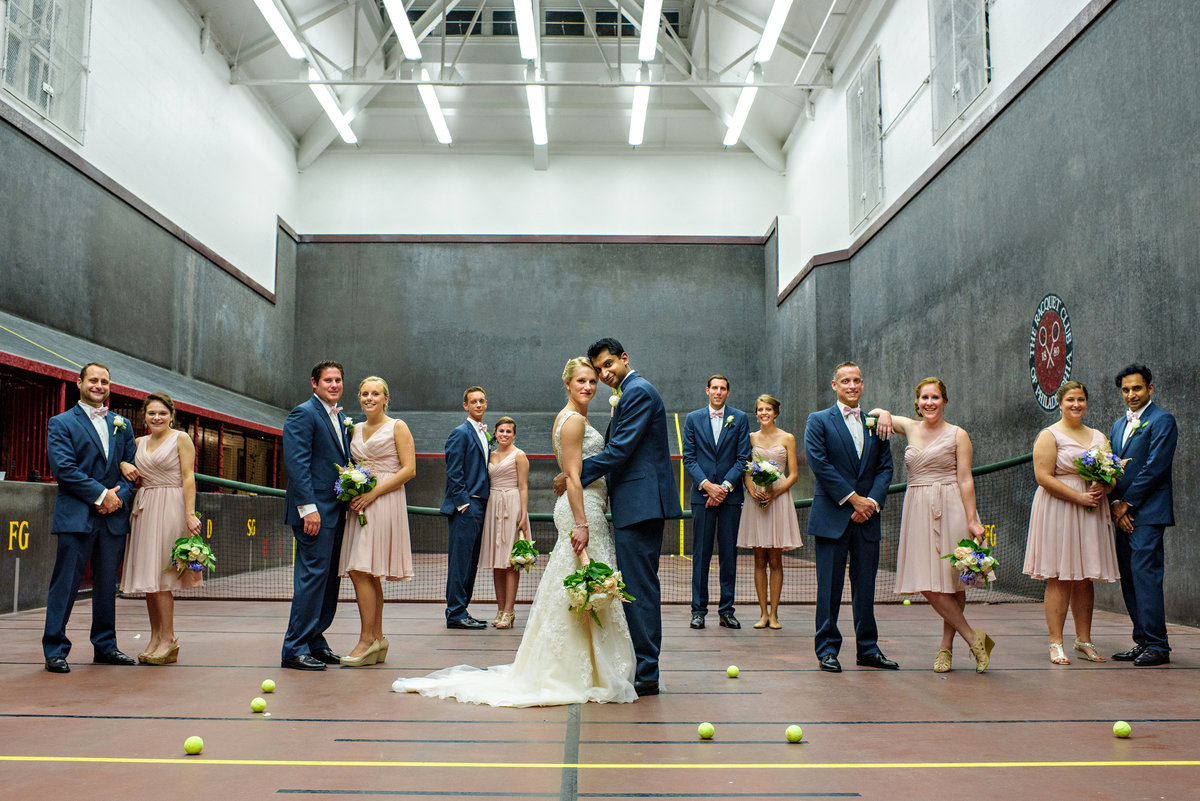 A bridal party pose on a tennis court at the Racquet Club of Philadelphia.