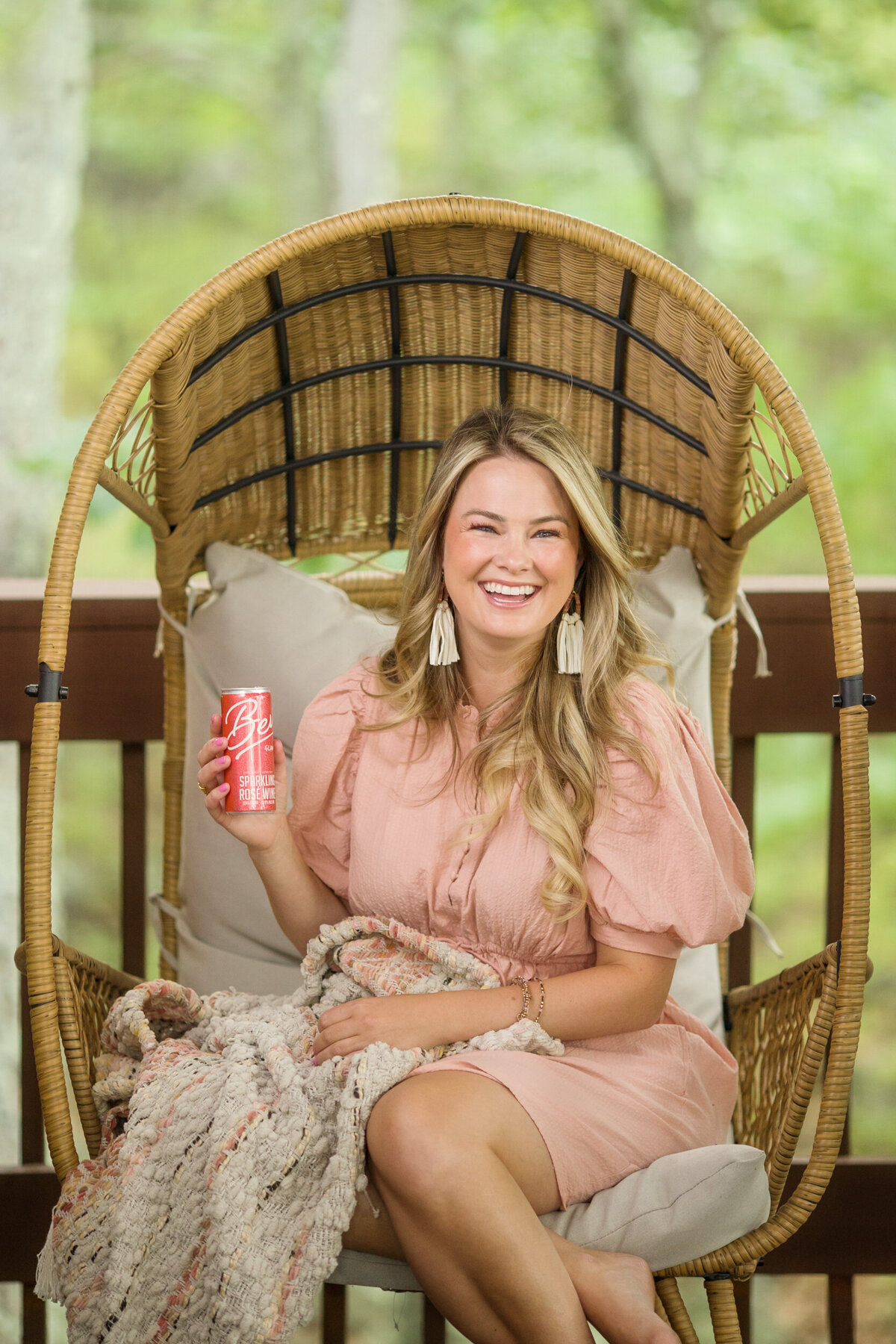Influencer branding photo of a woman holding a drink in a chair