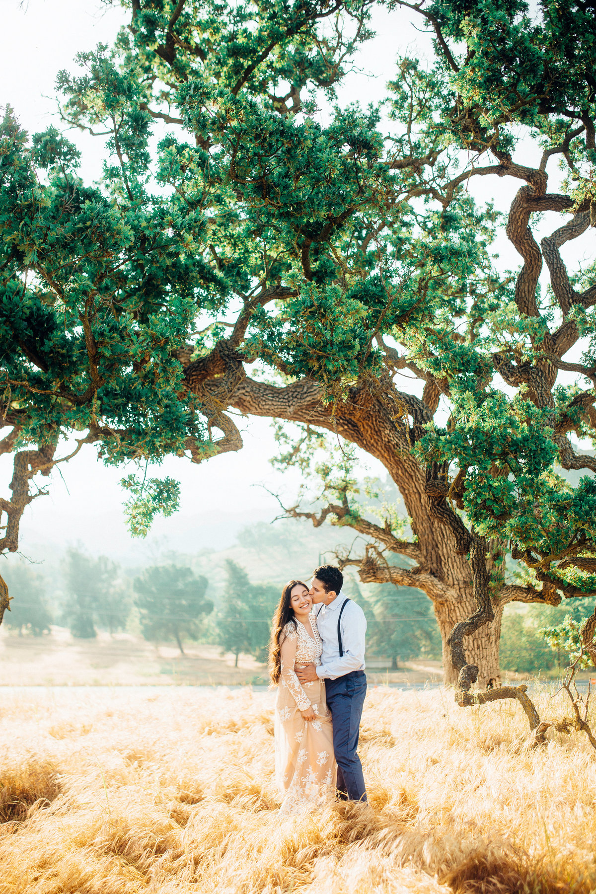 Engagement Photograph Of  Man Kissing a Woman On The Cheeks Los Angeles