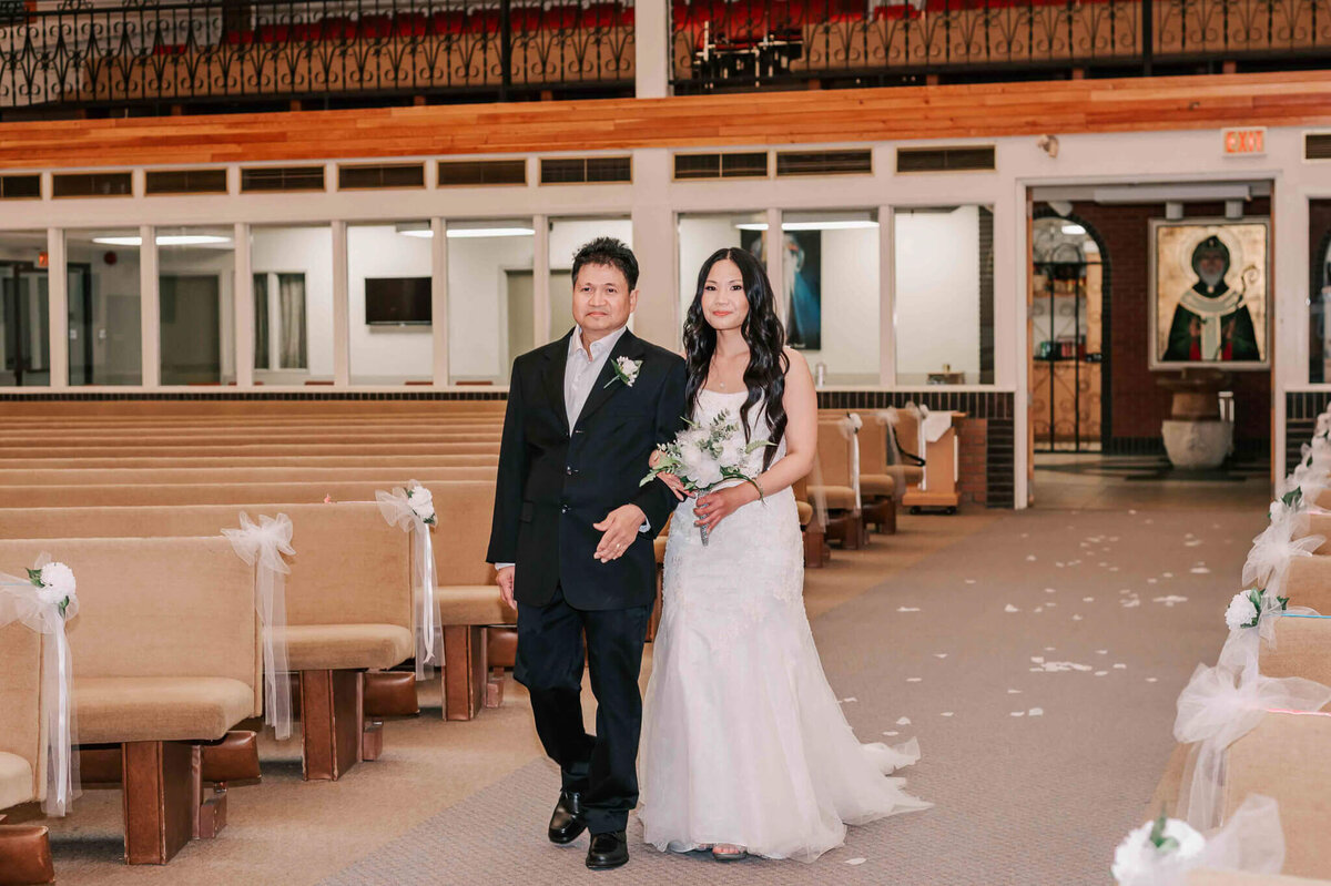 Bride walking down the aisle with her father.