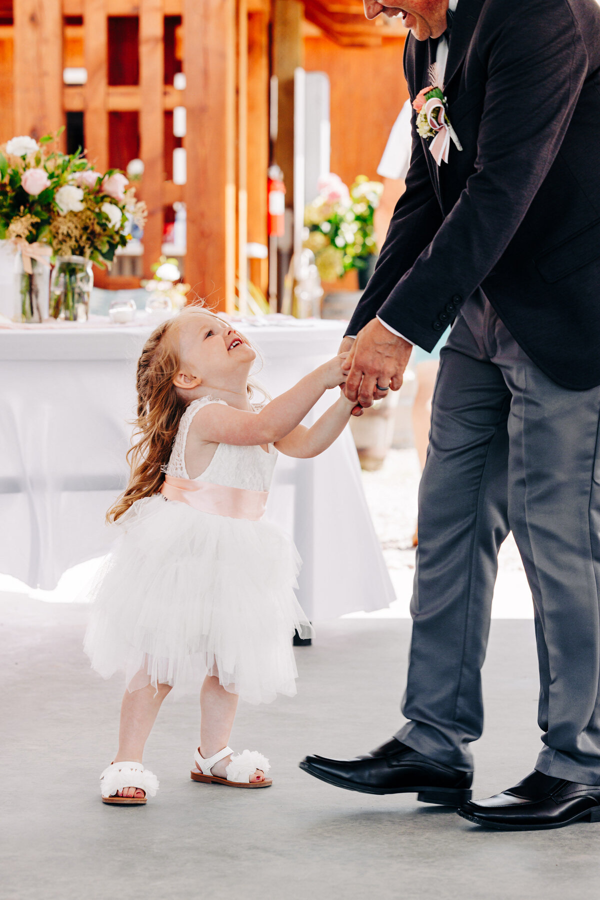Flower girl dancing with grandpa at Flathead Lake Forevers in Big Arm, MT