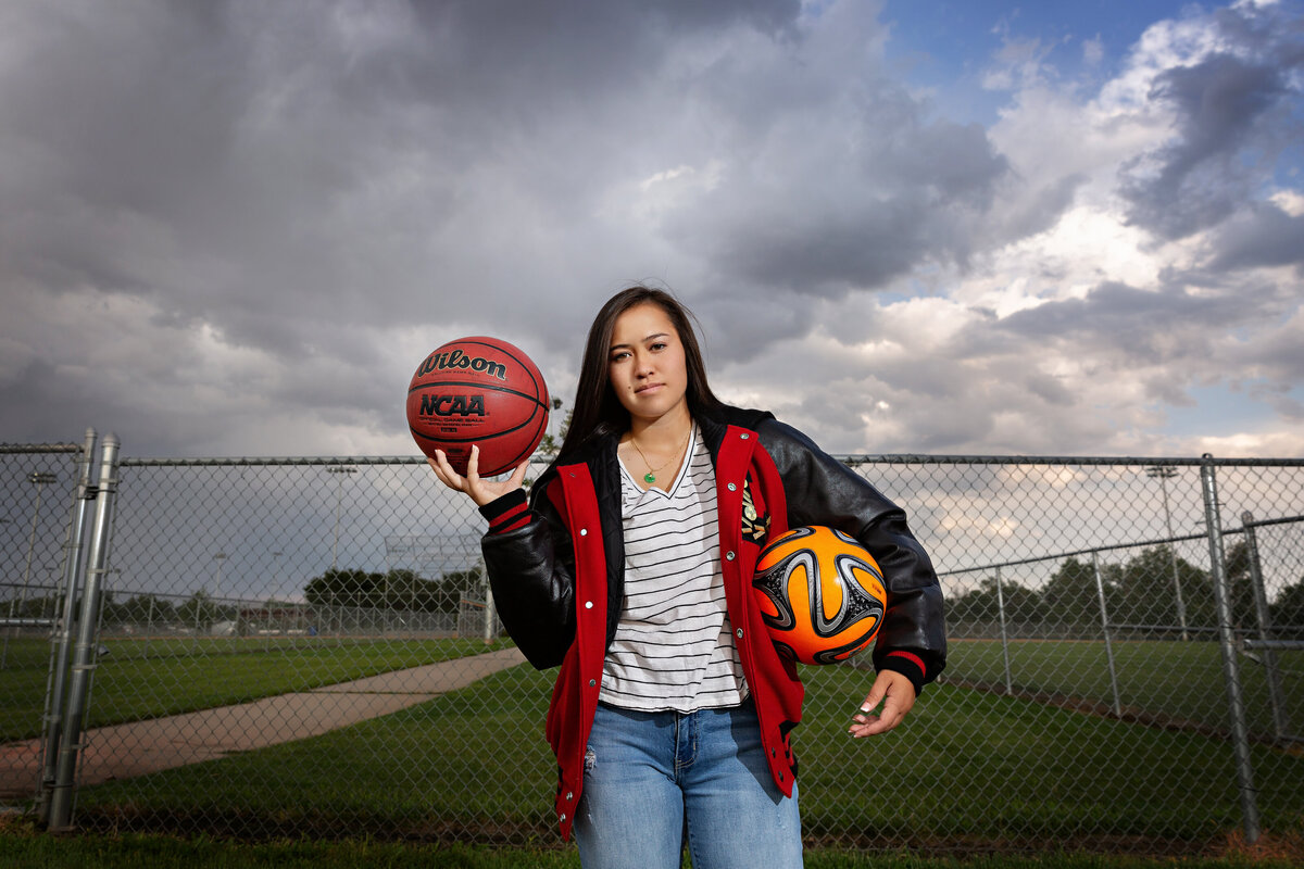 Sporty senior girl senior picture at sports field