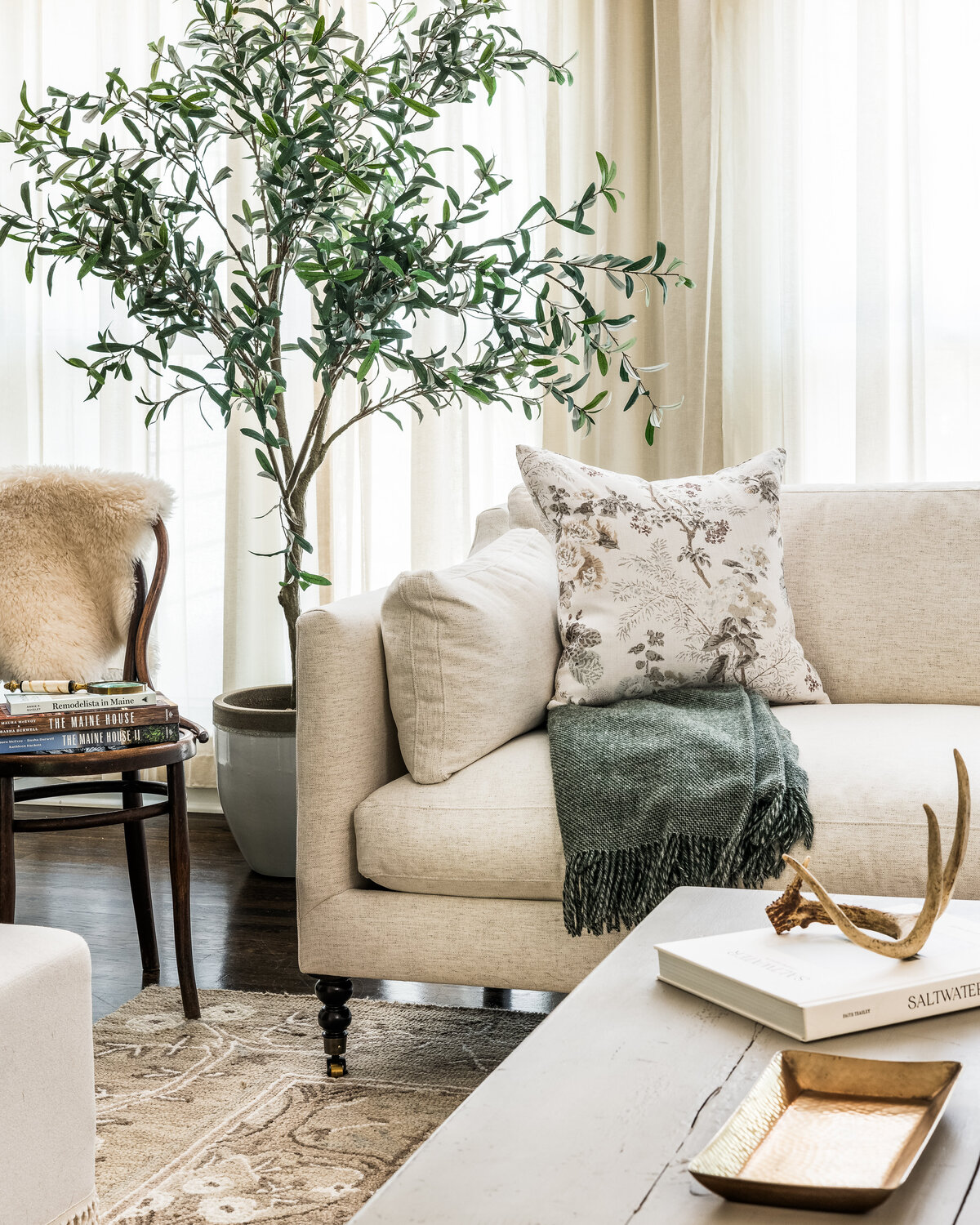 Refined seating area in Concord, NC, featuring a plush sofa, accent pillows, and a natural wood table.