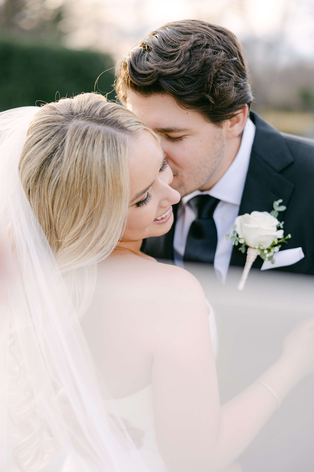 bride and groom portrait with veil floating at park chateau
