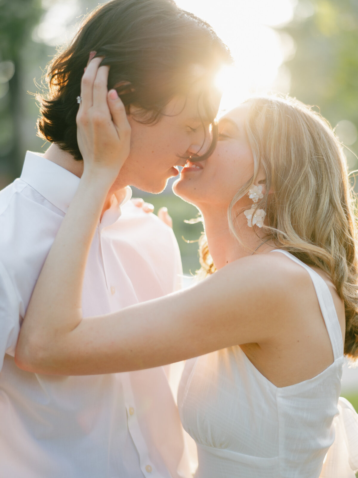 engaged couple at golden hour kissing in love
