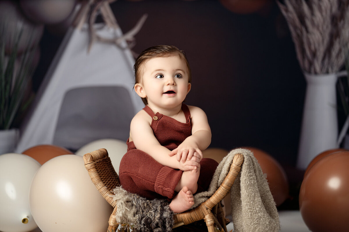 Baby Boy turns one wearing carter's romper by for the love of photography Lansing