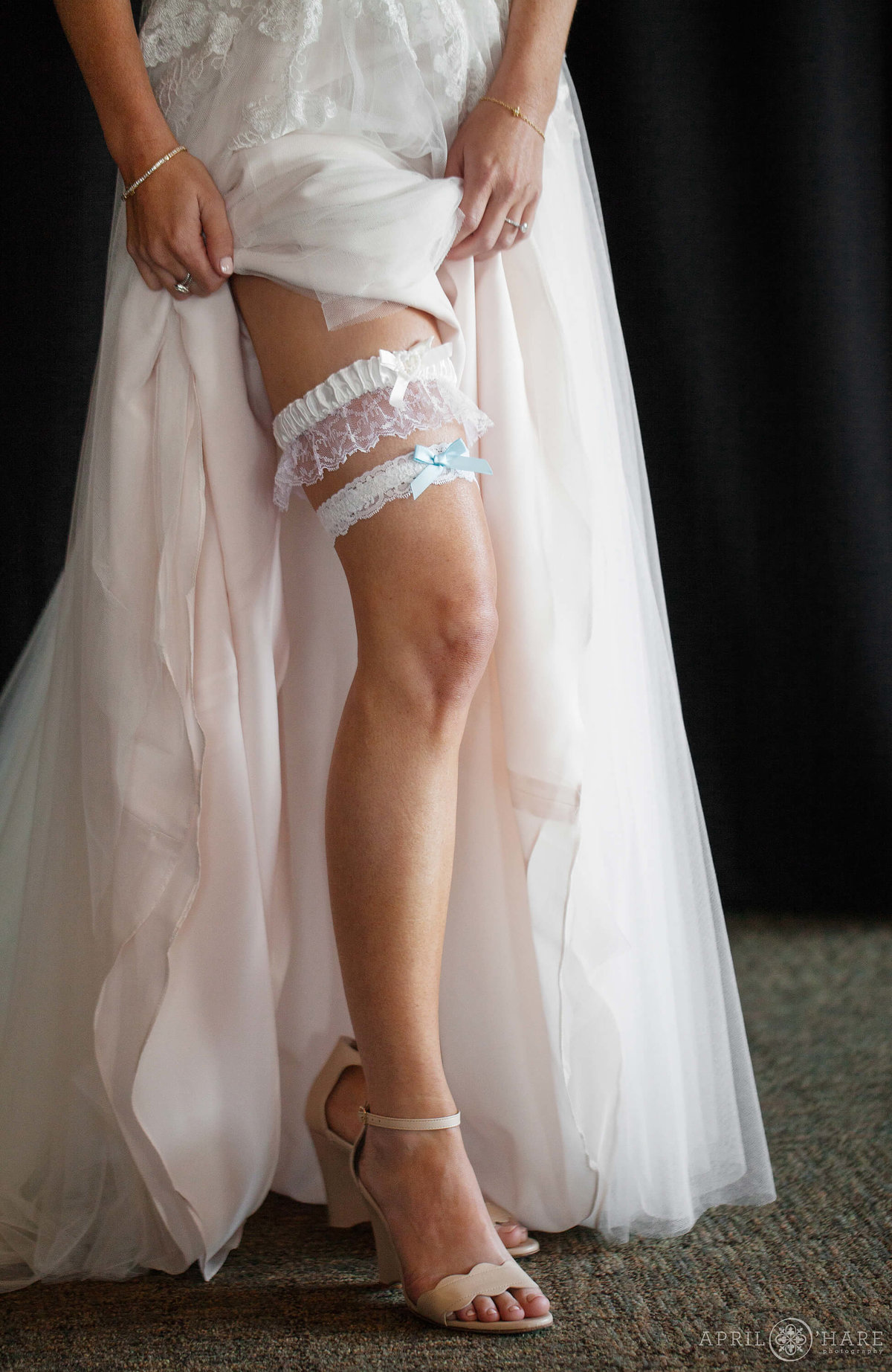 Pretty detail photo of a bride showing off her garter in Steamboat Springs Colorado