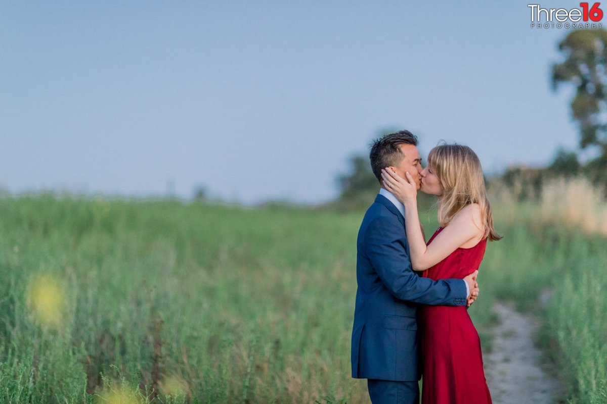 Engaged couple share a romantic kiss