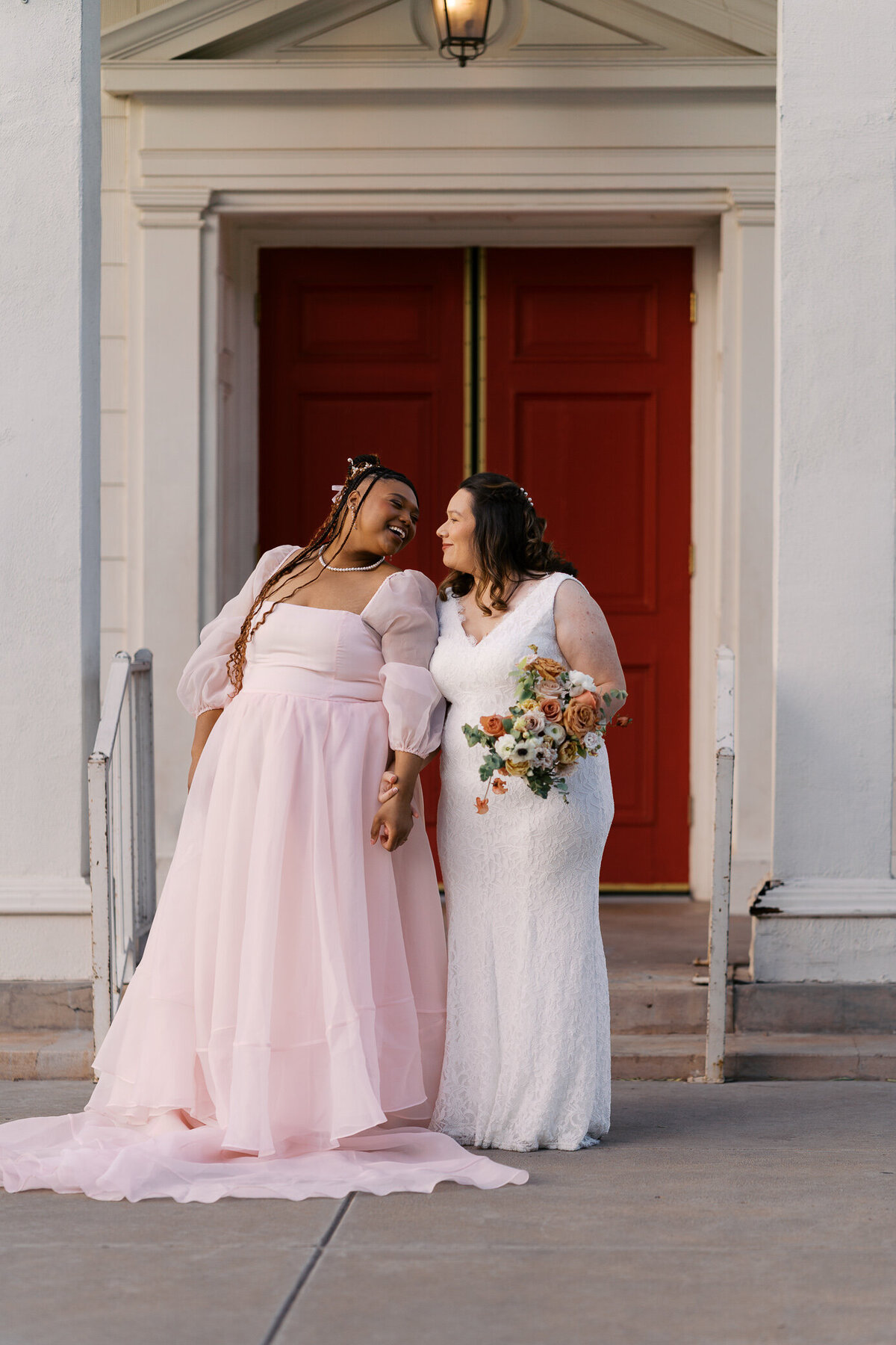 two-brides-chapel-door-pink-dress