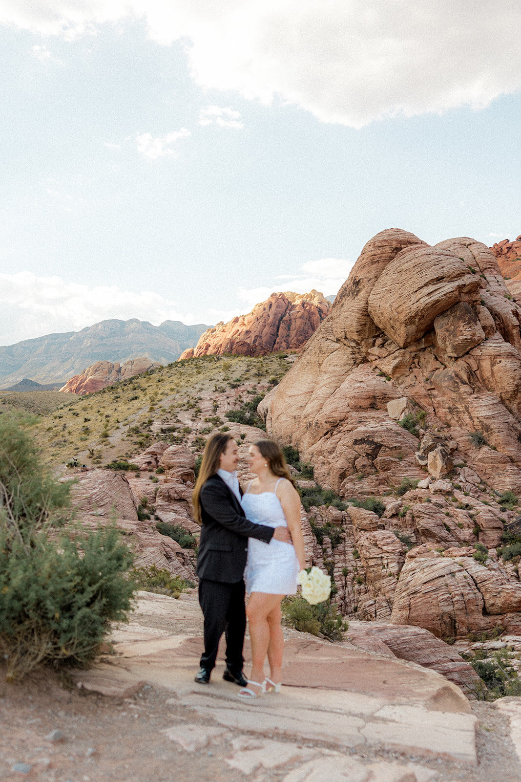 Engaged couple smiling at the Red Rock Canyon in Nevada