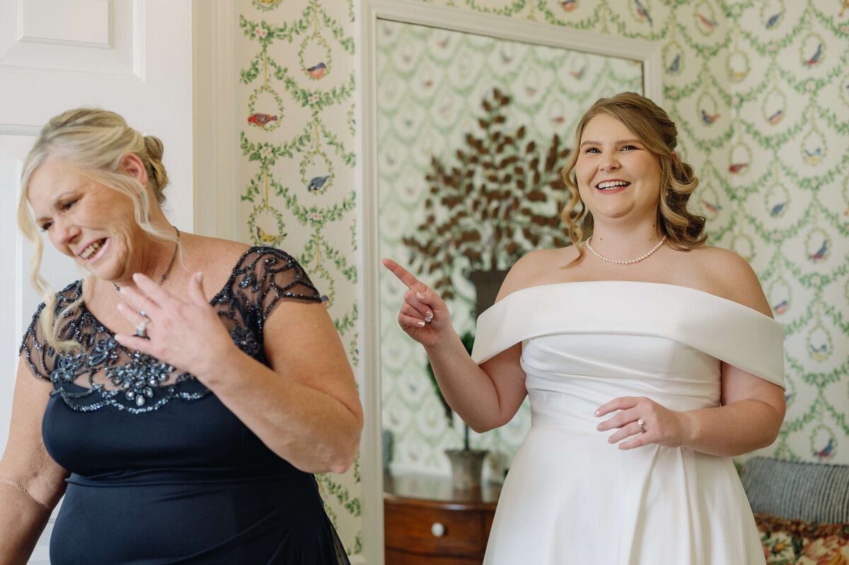 bridal suite photos with mother of the bride reacting to her daughter in her wedding dress and veil at middleburg community center