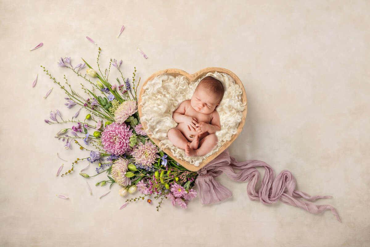 Charleston, SC #1 Baby Photographer poses infant for Newborn Photoshoot.