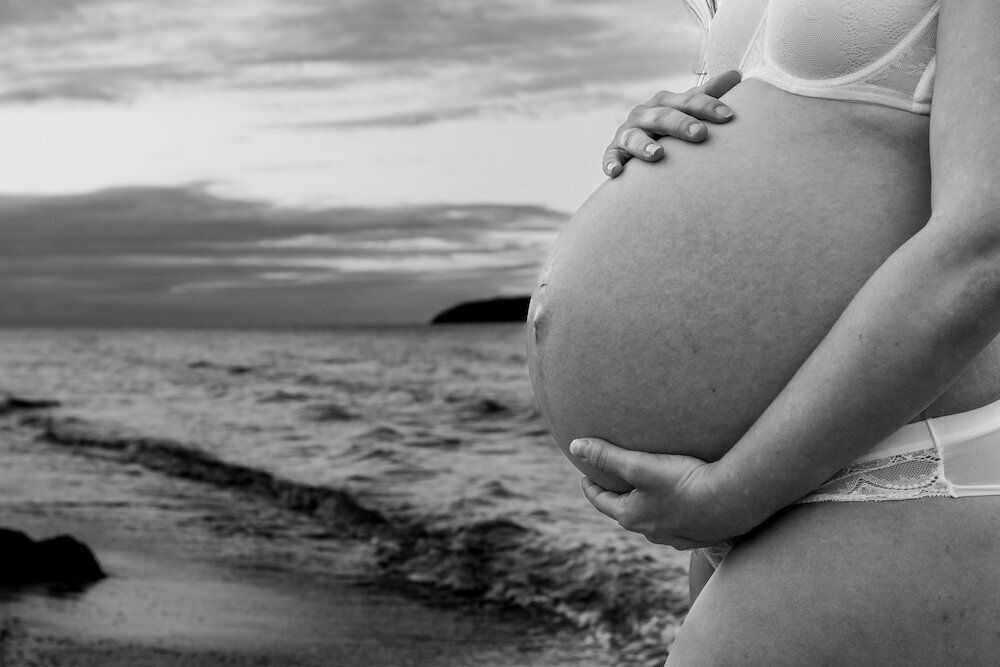 close up detail shot of baby belly at the sunset - Townsville Maternity Photography by Jamie Simmons