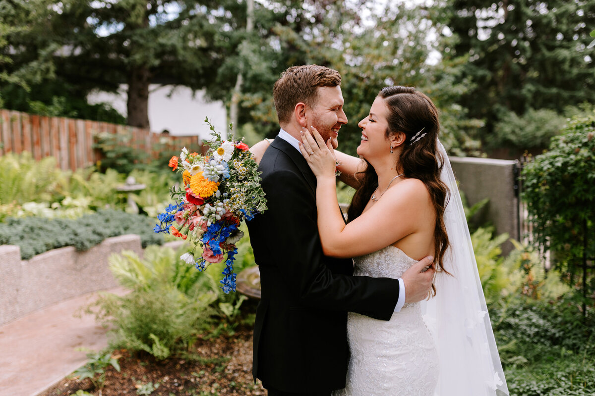 A bride and groom share a candid moment in Calgary, Alberta