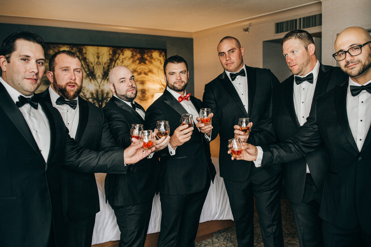 Groomsmen and groom getting ready with whisky