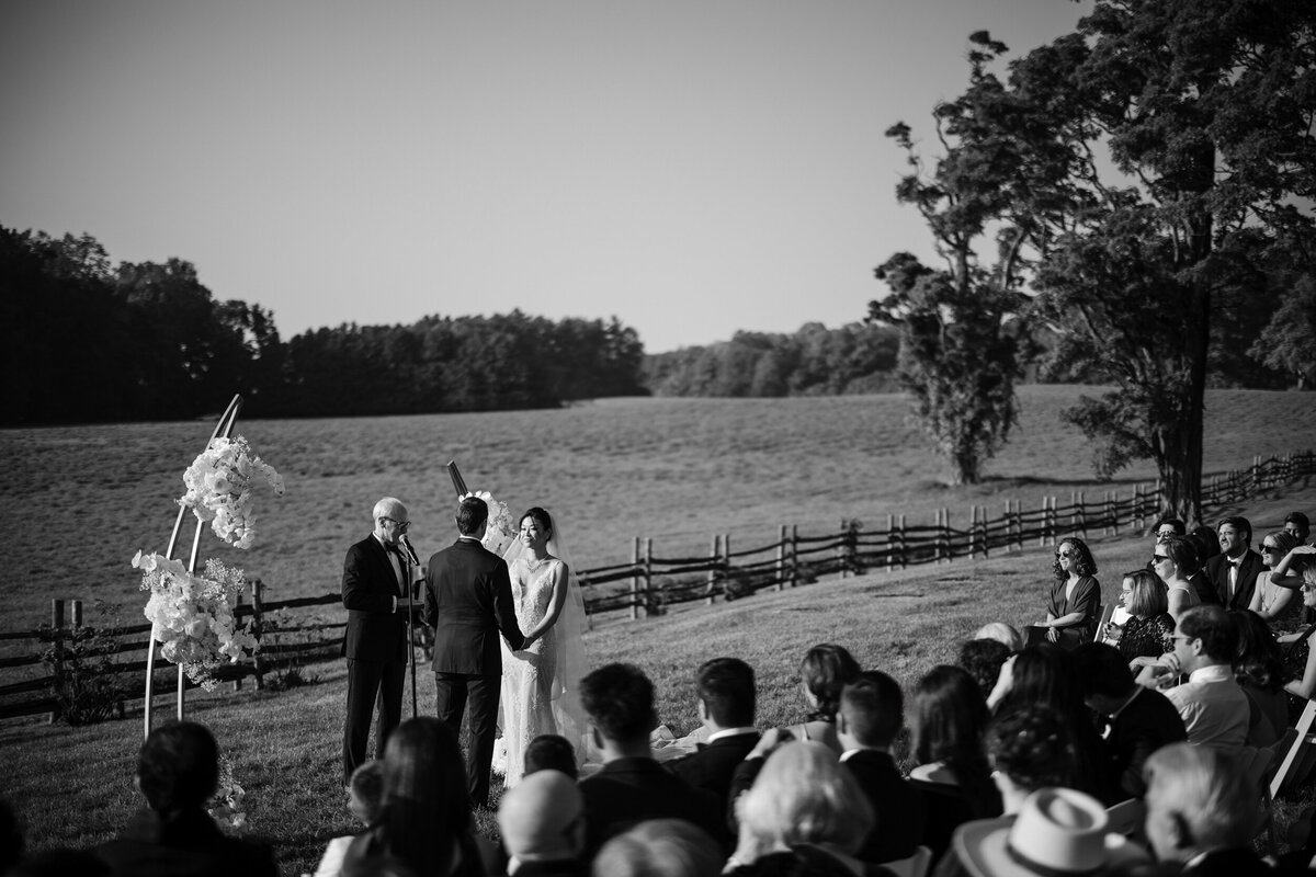 A black and white photo of a wedding ceremony at a destination wedding in Vermont