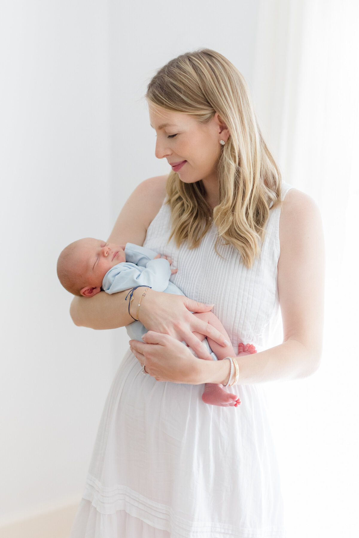 Mom holding baby at her Connecticut newborn photo session