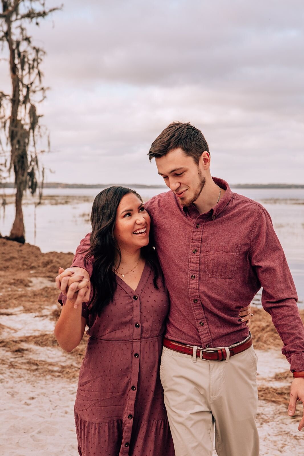 couple walking in sand at lake louisa in clermont florida