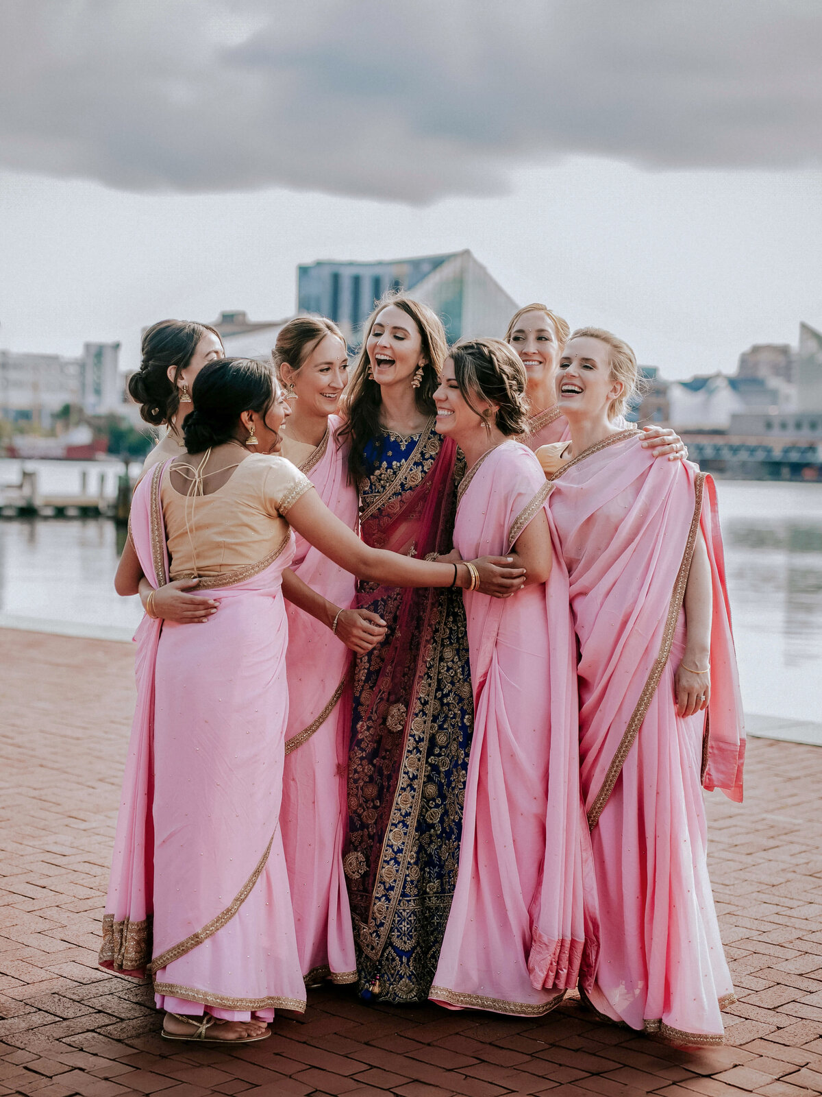 bridesmaids-hugging-bride-in-elegant-attire