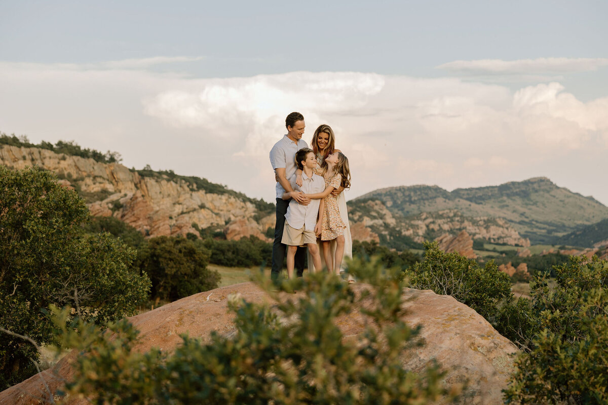 Candid Outdoor family session in the foothills of the Rocky Mountains, where the breathtaking scenery provides the perfect backdrop for vacation memories