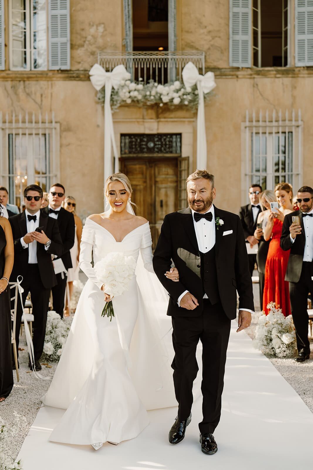 Bride-walking-down-aisle-French-chateau