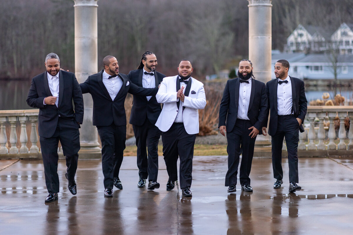 Groom with his groomsmen walking towards camera