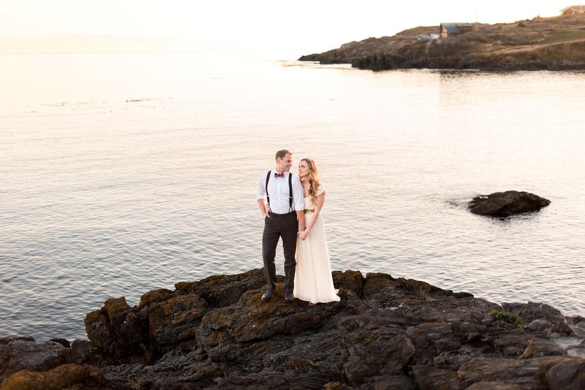 Bride and groom on the rocky waterfront at a Vashon Island wedding