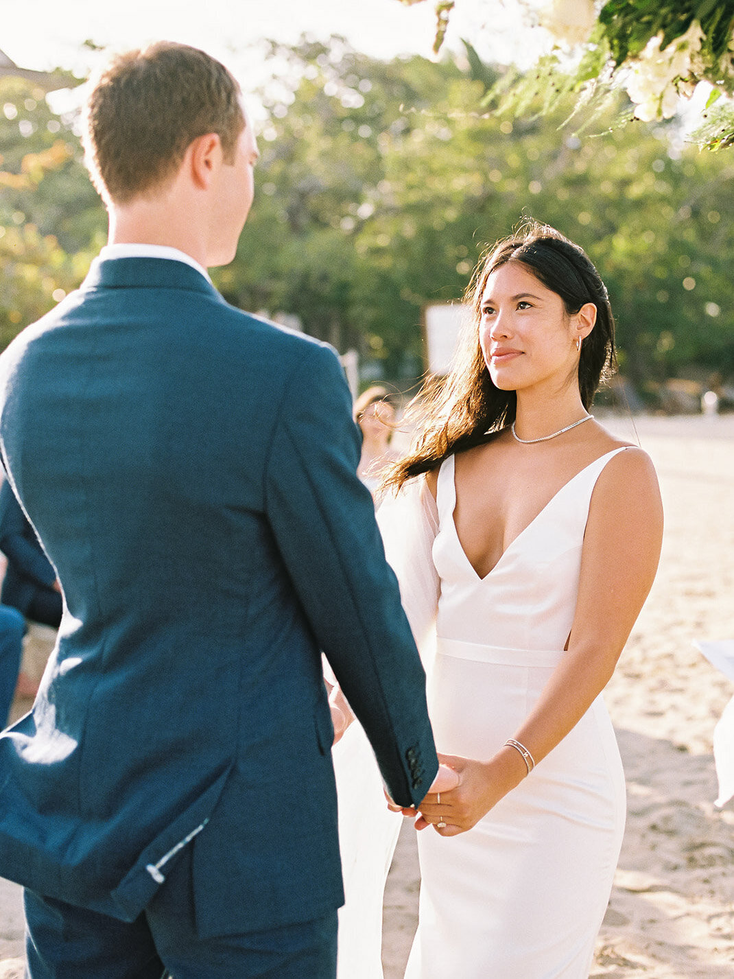 Couple exchanging vows at their beachside destination elopement