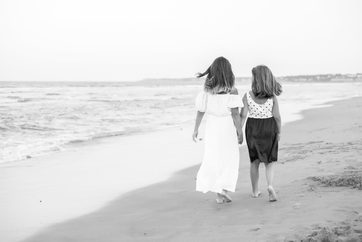 Sisters walking together on the beach in Wells Maine