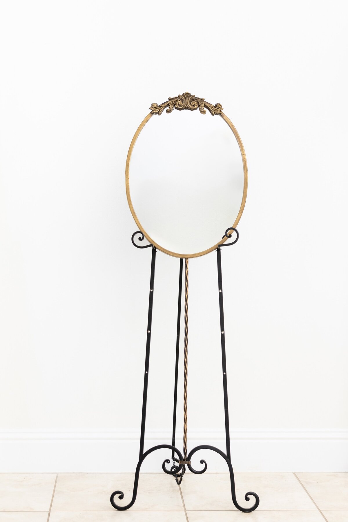 Medium oval mirror with ornate ornament on top