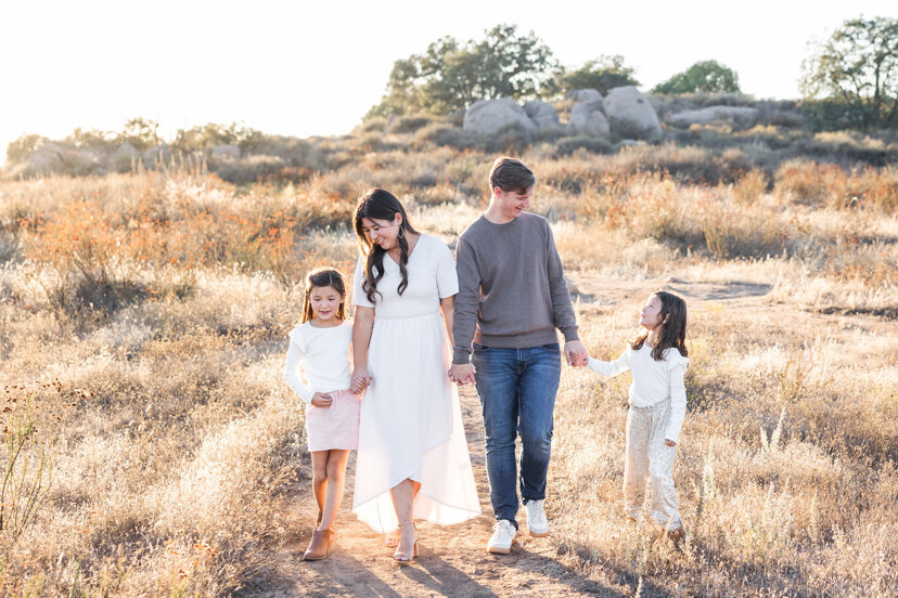 parents-and-children-walking-in-family-of-four-sitting-on-rock-wrights-field-san-diego