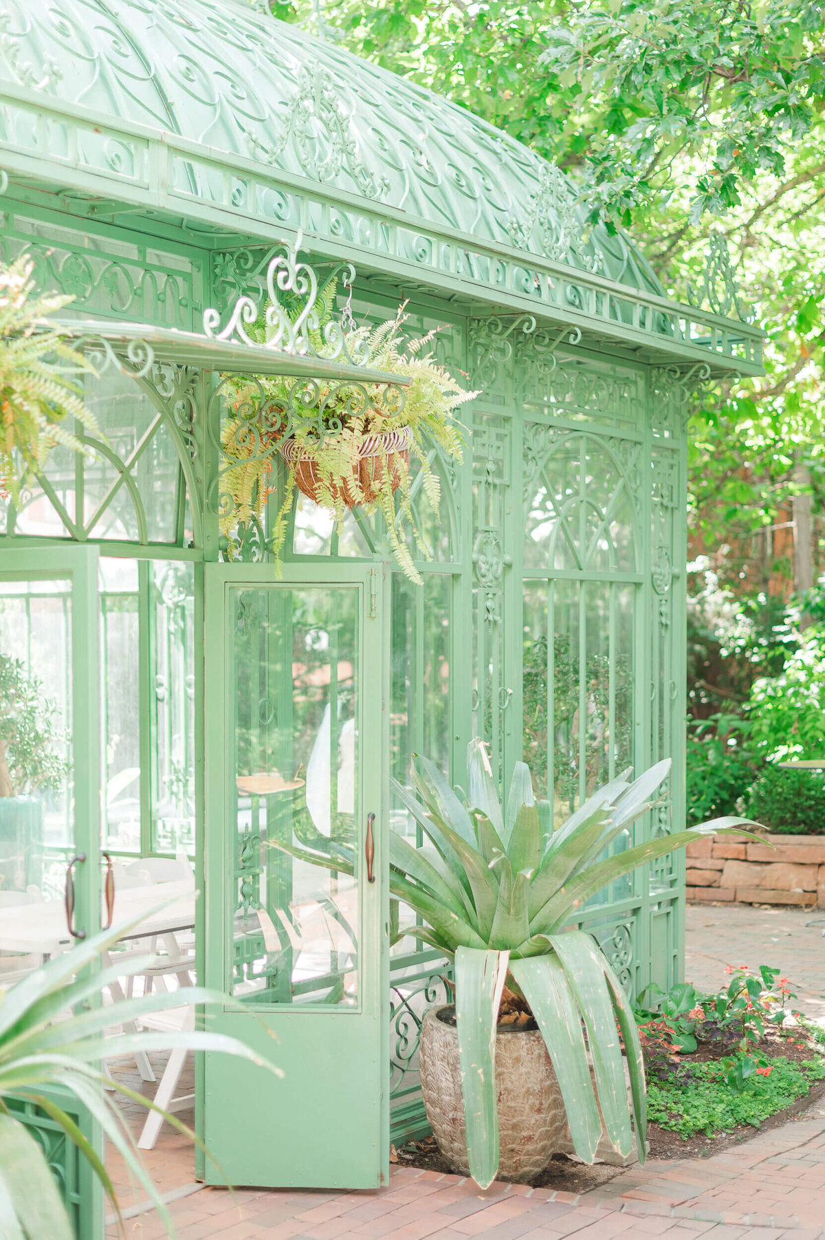 A green and glass greenhouse at the Denver Botanic Gardens.