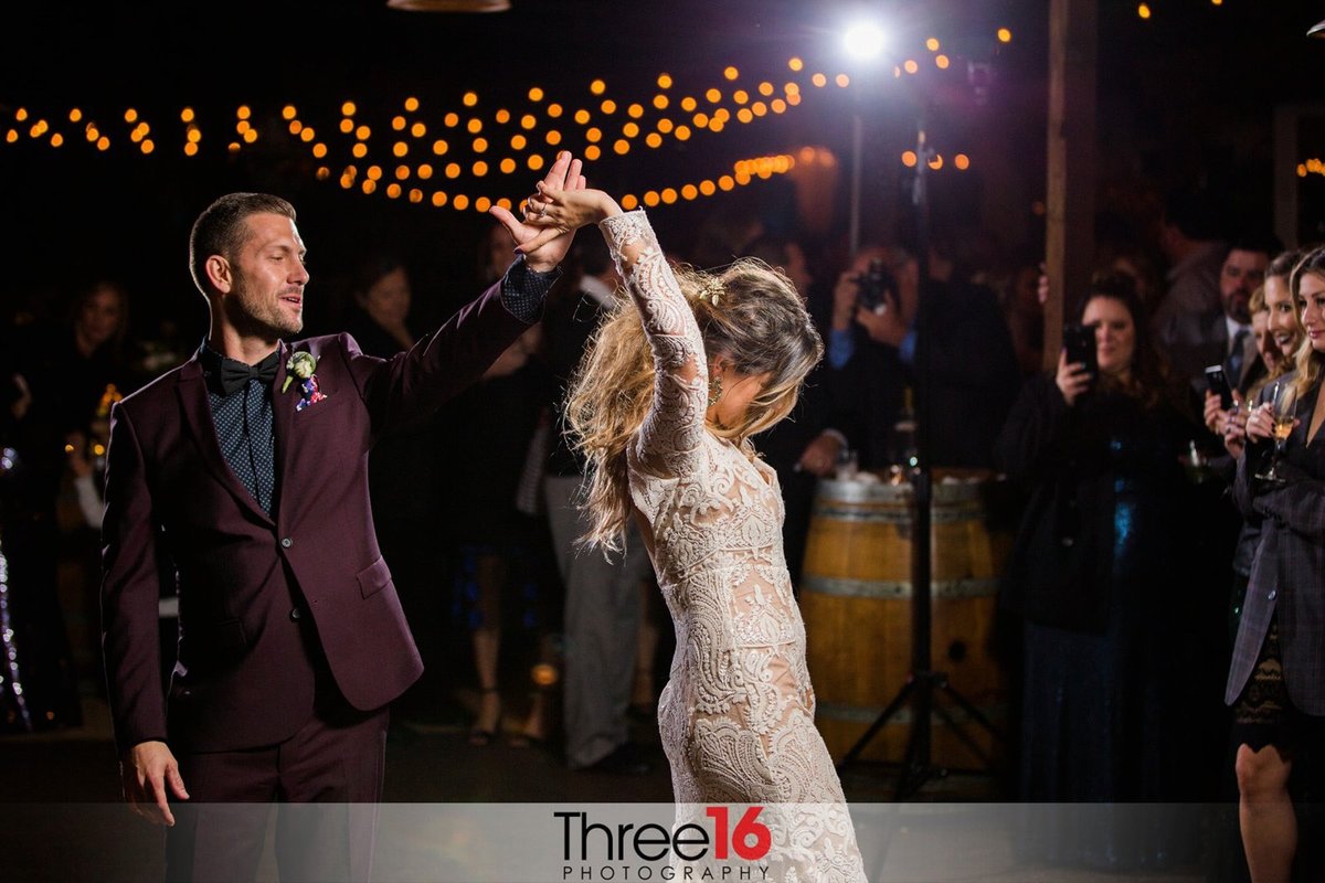Groom twirls his Bride on the dance floor during their first dance
