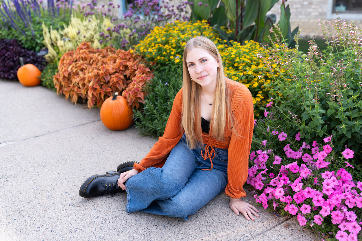 Girl looks back at the camera and smiles during her senior pictures at Old Cedar Bridge in Bloomington, Minnesota.