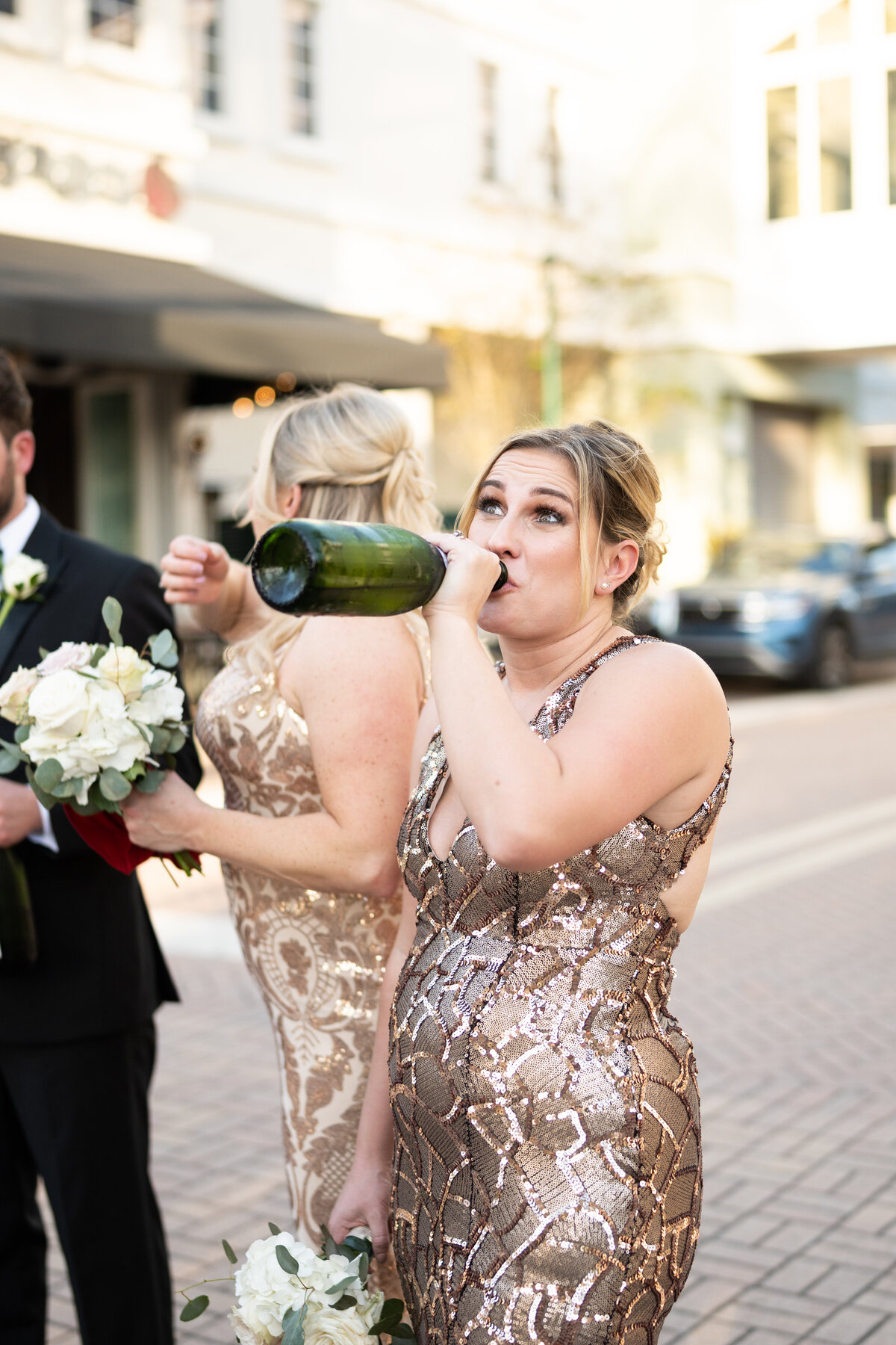 Bridesmaid drinking out of bottle