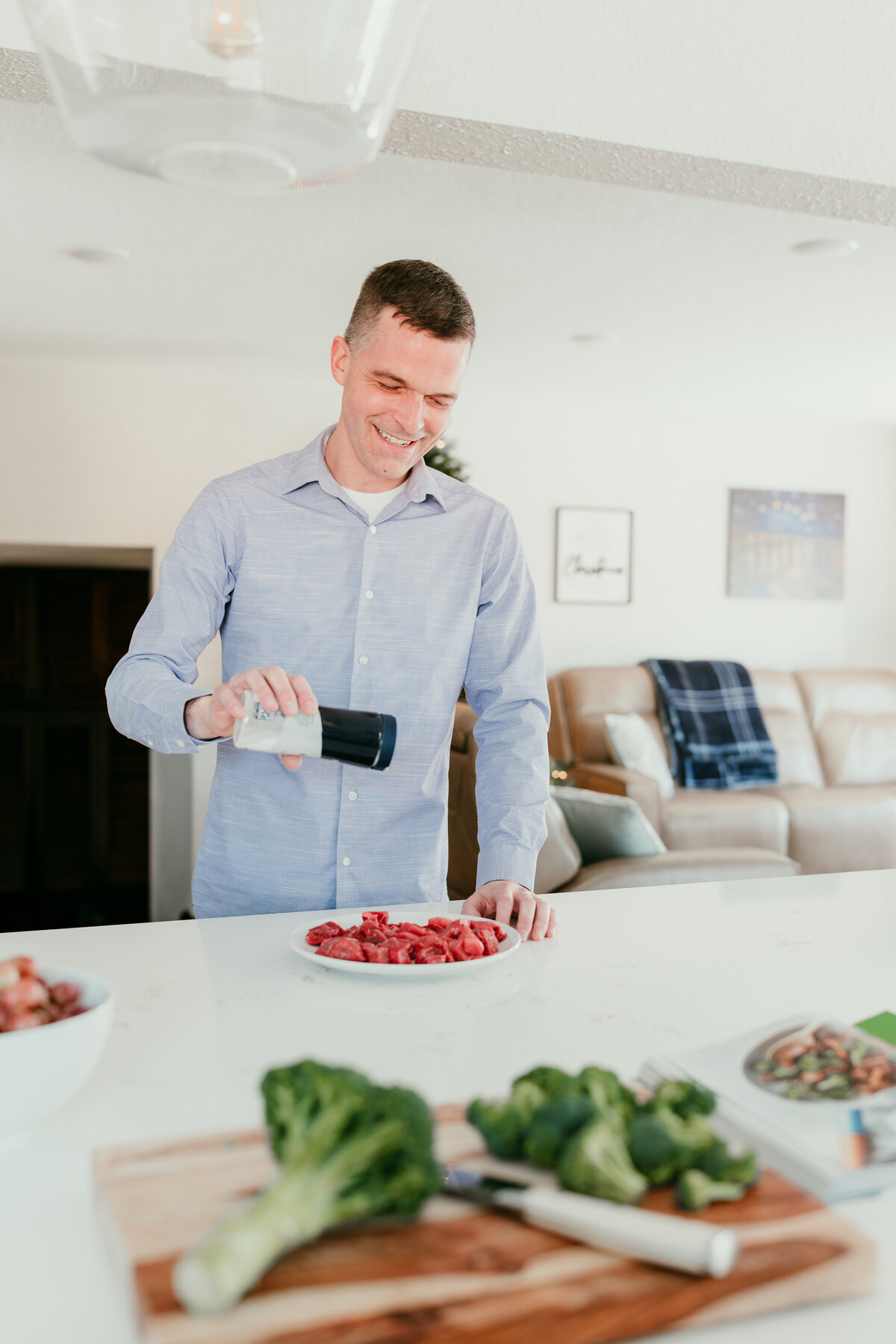Man preparing a meal in a bright, modern kitchen, showcasing a lifestyle-focused approach to dating profile photography.