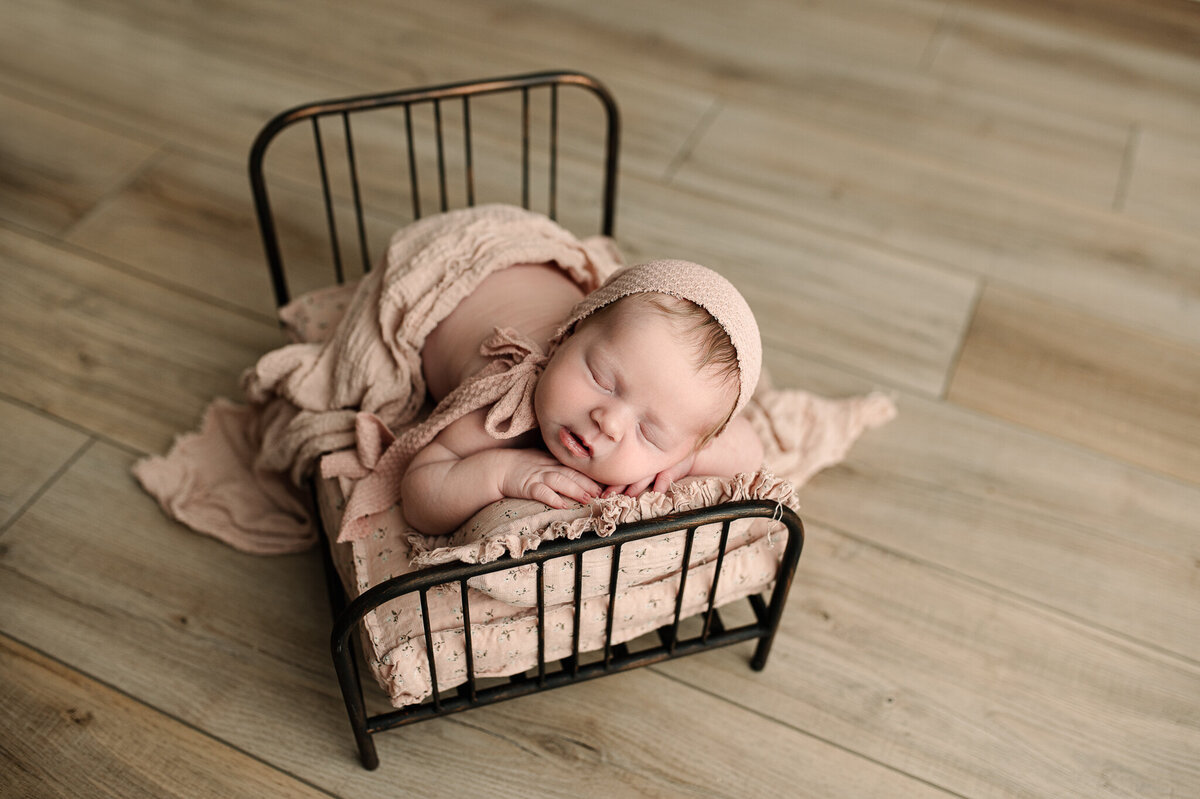 Baby in bed studio posed session