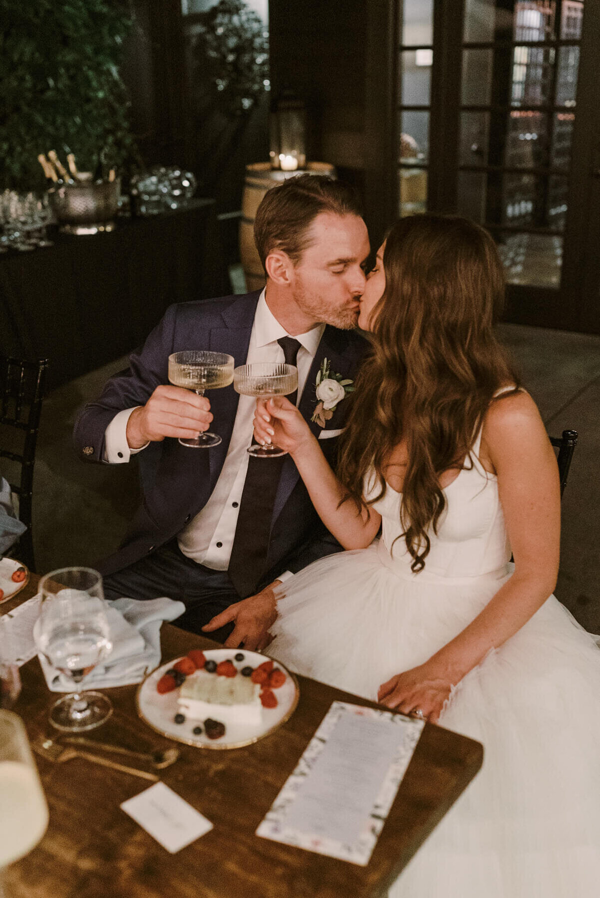 Bride and groom kissing at reception