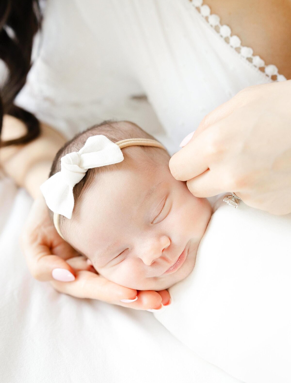 Sleeping smiling baby girl close up for newborn photos in DC