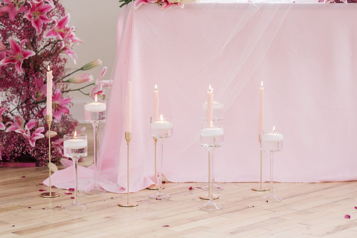 pink table cloth with floating candles