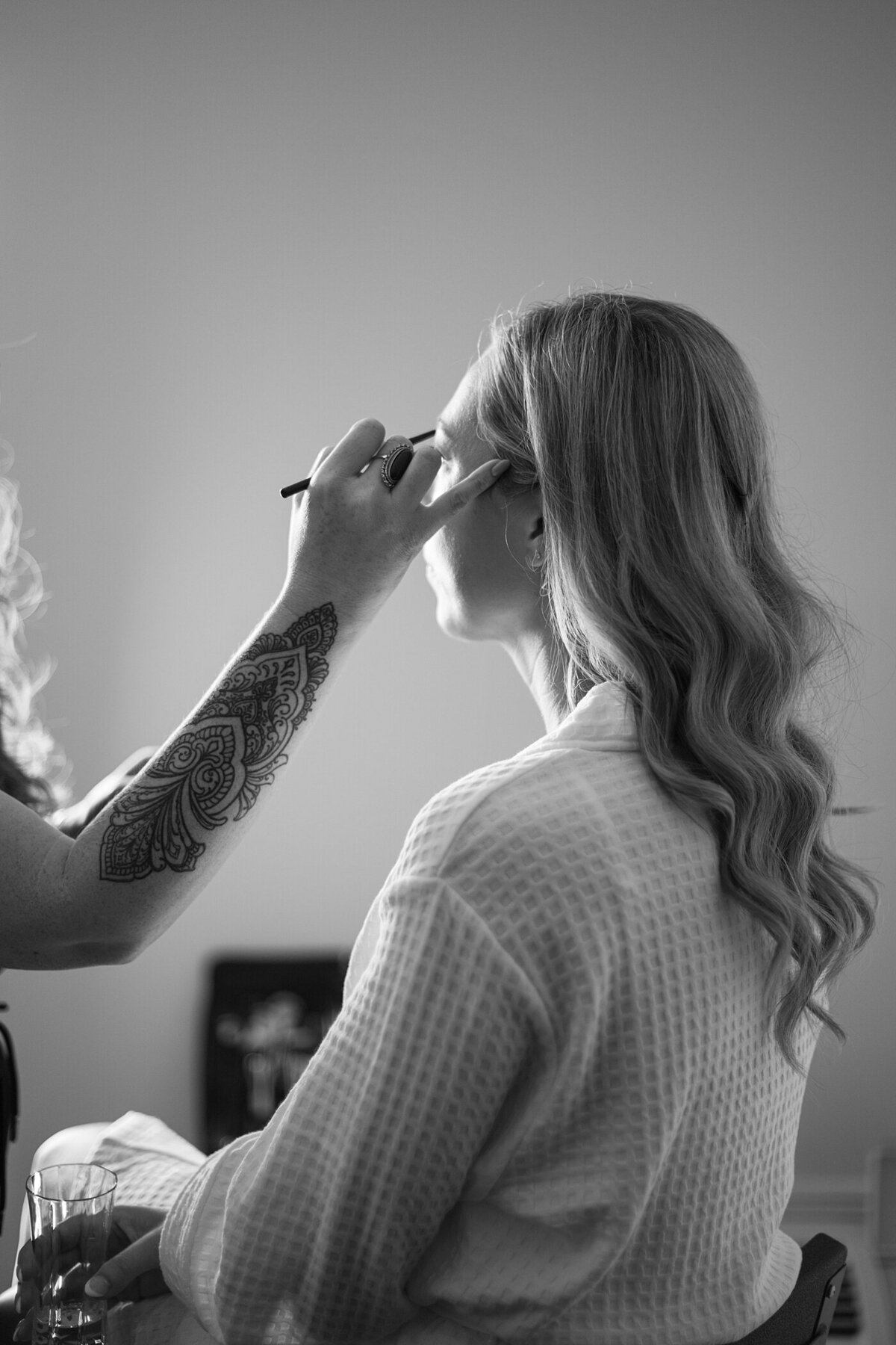 bride getting ready with makeup artist at the Pinnacle golf club wedding venue