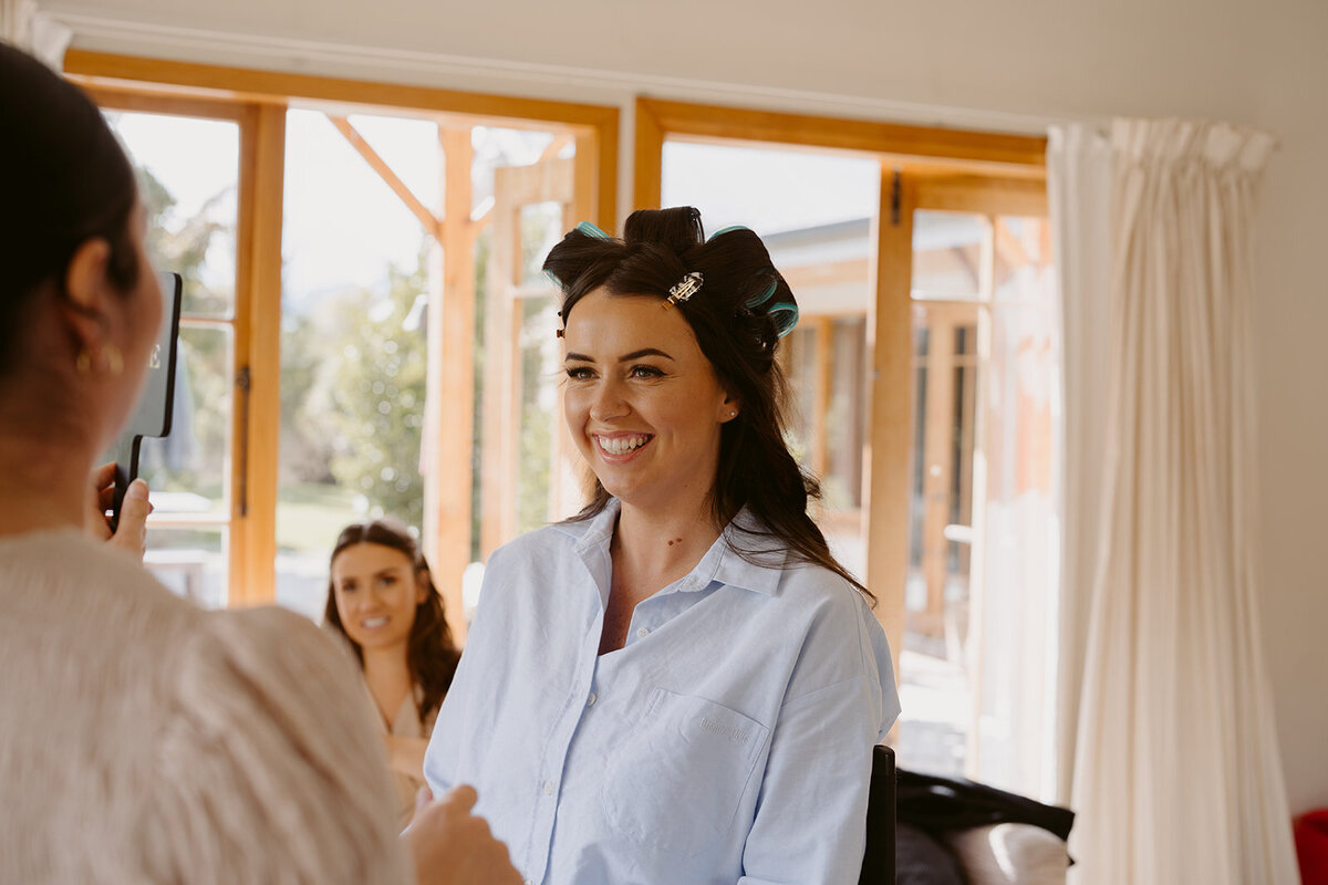 bridesmilinggettinghermakeupdonebypaigeshipstone