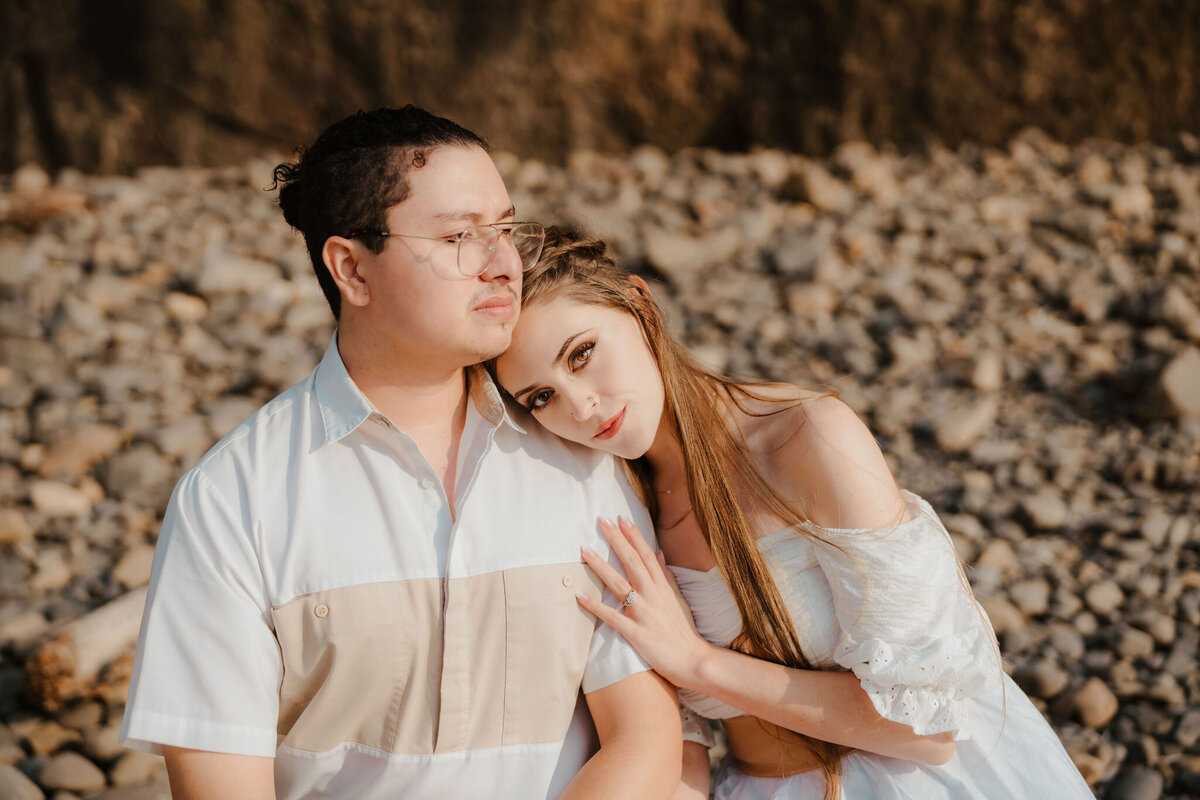 a woman resting her head on her fiance's shoulder